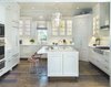 Modern home with Kitchen, Marble Counter, Refrigerator, Range Hood, Medium Hardwood Floor, Subway Tile Backsplashe, Drop In Sink, Range, Cooktops, and Pendant Lighting. Kitchen Photo 3 of Clubside Residence