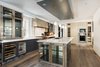 Modern home with Kitchen, Range Hood, Cooktops, Wine Cooler, Range, Refrigerator, Wall Oven, Pendant Lighting, Beverage Center, Microwave, Drop In Sink, Medium Hardwood Floor, and Wood Cabinet. Kitchen Photo 15 of Historic Hallam