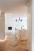 Modern home with Kitchen, Engineered Quartz Counter, White Cabinet, Wood Cabinet, Medium Hardwood Floor, Light Hardwood Floor, Laminate Cabinet, Stone Slab Backsplashe, Ceiling Lighting, Floor Lighting, Accent Lighting, Recessed Lighting, and Undermount Sink. K I T C H E N to L I V I N G Photo 7 of Brentwood