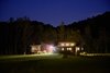 Modern home with Exterior, House Building Type, Concrete Siding Material, Wood Siding Material, and Flat RoofLine. Night shot from the entry road Photo 10 of Caney Fork Cabin