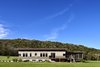 Modern home with Exterior, House Building Type, Wood Siding Material, Concrete Siding Material, and Flat RoofLine. View from the river Photo 4 of Caney Fork Cabin