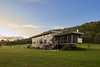 Modern home with Exterior, House Building Type, Wood Siding Material, Concrete Siding Material, and Flat RoofLine. View from the river side with screen porch Photo 6 of Caney Fork Cabin