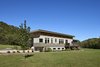 Modern home with Exterior, House Building Type, Wood Siding Material, Concrete Siding Material, and Flat RoofLine. View looking from the river Photo of Caney Fork Cabin