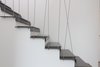 Modern home with Staircase, Metal Tread, Stone Tread, and Cable Railing. Existing wooden stair transformed into a steel/cement plate stair Photo 6 of Extension of a house in Geneva