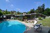 Modern home with Outdoor, Back Yard, Large Patio, Porch, Deck, Walkways, Grass, Large Pools, Tubs, Shower, Swimming Pools, Tubs, Shower, Pavers Patio, Porch, Deck, Planters Patio, Porch, Deck, Vertical Fences, Wall, Concrete Patio, Porch, Deck, and Wood Fences, Wall. This home design for the nuclear family of the 50's was perfect in terms of the perfect open plan featuring a central fireplace. with the house originally divided into a sleeping and living wings to allow separation. featuring the living area with open plan and the sleeping quarters set off from the hustle of day-to-day. The central hallway with skylights above allow for light to penetrate into the home, even at the center of the house. This feature was also one of the reasons it became an award winner by the NAHB. Fickett's fenestration was always well thought out, as he typically would use walls of plate glass, skylights above, clerestory windows with their tilt, jalousie windows louvered. Photo 2 of Winning Design | Edward H. Fickett, F.A.I.A | Mid-Century Modern | Encino, CA