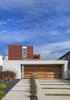 Modern home with Exterior, Green Roof Material, House Building Type, Wood Siding Material, Flat RoofLine, Concrete Siding Material, and Metal Roof Material. Dawnsknoll’s exterior sidings are cement panels and Resysta wood. The house’s front gate and garage are made from recycled wood. Photo of Dawnsknoll