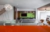 Modern home with Living Room, Bookcase, Coffee Tables, Table, Sofa, Shelves, Storage, Pendant Lighting, Chair, Concrete Floor, and Recessed Lighting. Dawnsknoll optimizes the capture of natural light and cross ventilation, keeping down electrical costs. Interior/exterior courtyards, as well as the master and living room sliders, help circulate breezes. Sustainable heating is also introduced through radiant floor heating and domestic water heating throughout the house. Photo 5 of Dawnsknoll