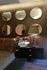 The set of mirrors on the wall above the bed balances the warm tone of other elements of this bedroom. Photo 4 of In the details modern home