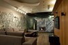 The wall in the terrace bar, which houses its own cosy fireplace, are feverishly done up in a custom mural. Photo 5 of In the details modern home