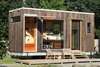 Modern home with Exterior, House Building Type, Wood Siding Material, and Green Roof Material. A gullwing door opens to The Sturgis's "obsession space"—a room that can be configured to house whatever the owner can't live without, whether that's a wine collection, mountain bike or motorcycle. Photo 2 of The Sturgis
