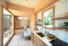Modern home with Living Room, Accent Lighting, Sofa, Coffee Tables, and Light Hardwood Floor. The queen-size bed nests in the ceiling, dropped at night with a switch in the kitchen, till it sits just above the West Elm sofa and modular walnut coffee tables. Photo 3 of The Sturgis
