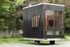 Modern home with Exterior and Wood Siding Material. The Adirondack mobile cabin is a 100-square-foot escape that can drop its wheels and hitch to become your backyard escape, or stay mobile to be your weekend glamping headquarters. Photo of The Adirondack