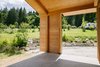 Modern home with Outdoor, Field, Boulders, Walkways, Large Patio, Porch, Deck, Wood Patio, Porch, Deck, Concrete Patio, Porch, Deck, Stone Patio, Porch, Deck, and Decomposed Granite Patio, Porch, Deck. View from the Gallery patio toward the stone stair and pear orchard beyond. Retro rental trailer at right. Photo of Modern Timber Frame