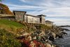 Modern home with Outdoor, Stone Patio, Porch, Deck, Boulders, and Back Yard. The Lighthouse, ocean side, with the adjacent cottage in the background. Photo of The Lighthouse