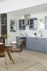 Modern home with Kitchen, Colorful Cabinet, Wood Cabinet, Engineered Quartz Counter, Light Hardwood Floor, Recessed Lighting, Cooktops, Range Hood, Range, and Undermount Sink. Custom shaker cabinets are painted a shade of blue to compliment the ocean view. Photo 4 of The Lighthouse