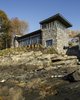 Modern home with Outdoor, Stone Patio, Porch, Deck, Boulders, Shrubs, Back Yard, Trees, and Slope. Blending into the surroundings. Photo 11 of The Lighthouse
