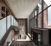 Modern home with Staircase, Concrete Tread, and Metal Railing. Sculptural glass entryway marrying historic architecture and modern Photo of Hotel Henry Urban Resort at Richardson Olmsted Campus