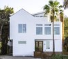 Modern home with Exterior, House Building Type, Green Roof Material, Stucco Siding Material, and Wood Siding Material. Front Facade-The third floor planter and accents of wood were incorporated into the design to soften the homes contemporary aesthetic Photo 8 of The Live Oak House