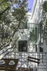 Modern home with Small Patio, Porch, Deck, Exterior, House Building Type, Green Roof Material, Stucco Siding Material, and Concrete Siding Material. Master balcony designed to give the experience of being in and living below the canopy of a tree. The windows are positioned and oriented to allow the ocean breezes to flow through the home Photo 12 of The Live Oak House