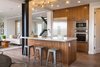 Modern home with Kitchen, Marble Counter, Wood Cabinet, Ceiling Lighting, Refrigerator, Wall Oven, Medium Hardwood Floor, Glass Tile Backsplashe, Cooktops, Range Hood, Microwave, Dishwasher, and Undermount Sink. Kitchen and island Photo 5 of The Abernathy