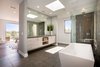 Modern home with Bath Room, Quartzite Counter, Porcelain Tile Floor, Undermount Sink, Freestanding Tub, Enclosed Shower, Ceiling Lighting, Porcelain Tile Wall, One Piece Toilet, and Corner Shower. Master bathroom suite. Photo 11 of The Abernathy
