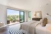 Modern home with Bedroom, Bed, Dresser, Ceiling Lighting, and Medium Hardwood Floor. Master bedroom and deck Photo 9 of The Abernathy