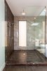 Modern home with Bath Room, Quartzite Counter, Corner Shower, Ceiling Lighting, and Porcelain Tile Wall. Master shower with Quartzite wall. Photo 12 of The Abernathy