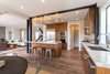 Modern home with Kitchen, Marble Counter, Wood Cabinet, Ceiling Lighting, Refrigerator, Microwave, Medium Hardwood Floor, Glass Tile Backsplashe, Wall Oven, Dishwasher, Cooktops, Range Hood, and Undermount Sink. Kitchen Photo 6 of The Abernathy