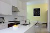 Modern home with Kitchen, Engineered Quartz Counter, Light Hardwood Floor, White Cabinet, Wood Cabinet, Glass Tile Backsplashe, Ceiling Lighting, Range, Range Hood, and Undermount Sink. Kitchen Photo 6 of The Hearn House