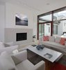 Modern home with Living Room, Sofa, Chair, Coffee Tables, Ceiling Lighting, Light Hardwood Floor, Wood Burning Fireplace, Floor Lighting, and Gas Burning Fireplace. Living Room Photo 10 of The Hearn House