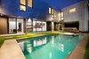 Modern home with Outdoor, Back Yard, Grass, Large Pools, Tubs, Shower, and Concrete Patio, Porch, Deck. The Wave House by Mario Romano featuring Infratech Flush Mount WD-Series Dual Element Heaters Photo 3 of The Wave House by Mario Romano
