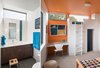 Kid's bedroom with loft sleeping area and reading nook. A whimsical orange color wraps down the ceiling and back wall. Photo 8 of Sunset House modern home