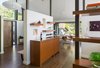 Removing a massive fireplace from the center of the home and replacing it with much smaller art-wall and built-ins creates a visual connection, making the spaces feel larger without adding on. Photo 3 of Mid Century Re-Modern modern home