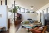 Modern home with Living Room, Chair, Sofa, and Coffee Tables. The living room was re-oriented to take advantage of indoor-outdoor living with large sliders and an indoor-outdoor fireplace. The space is now a well-used extension of the living area. Photo 2 of Mid Century Re-Modern