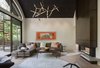 Modern home with Living Room, Pendant Lighting, and Sectional. A lift raises and lowers a large metal panel that hides the TV. Photo 3 of Flood Damaged Remodel