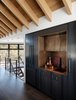 Modern home with Kitchen, Metal Counter, Beverage Center, Metal Cabinet, Refrigerator, Undermount Sink, and Dark Hardwood Floor. We think this centrally located custom metal/brass bar is an entertainers dream! Photo 3 of Modern Cabin