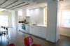 White Box – Kitchen and Living spaces
We were asked by our client to remove two walls in order to open the small space that measures 17’ wide by 31’ long. Two simple ideas drove the design; Light and duality of space. Guided by both we started with what we believe is critical to every project – process of discovery.
The proposed design uses white and dominating color for walls, cabinets and the built in bench. Light colored wood floor will add to the light appearance of space shell. As all dividing walls were removed, perimeter walls were charged with functions; linear kitchen, bench next to dining table, and pantry closet. Avoiding upper cabinets allow the design to be open and make use of the wall as a dynamic element –otherwise a monochromatic space. The newly created functional void connects both ends of space and creates what appears to be a larger and brighter spatial experience. Photo of NY Metro modern home