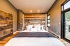 The master bedroom makes copious use of reclaimed barn wood. Photo 20 of Ascent Estes Park modern home