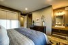 Downstairs features two bedrooms each with their own ensuite vanity sinks. Photo 10 of Ascent Estes Park modern home