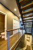 Stainless steel infill panels adorn the central stairways accessing all three levels of Ascent. Photo 9 of Ascent Estes Park modern home