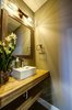 The hall powder bath features the home's signature use of Parallam beams repurposed as countertops and shelves. Photo 8 of Ascent Estes Park modern home