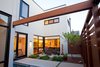 Modern home with Outdoor, Plunge Pools, Tubs, Shower, Small Patio, Porch, Deck, Wood Fences, Wall, Garden, and Horizontal Fences, Wall. A void was cut from the footprint providing a private vegetated courtyard sheltered from the urban street by the stair massing and steel gate. A Zen-like plunge pool situates itself at the corner of the court, visible from many areas of the house and welcomes guests along their entry journey. Photo 2 of City Cottage