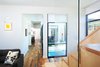Modern home with Plunge Pools, Tubs, Shower, Medium Hardwood Floor, Staircase, Glass Railing, and Wood Tread. A Zen-like plunge pool situates itself at the corner of the court, visible from many areas of the house and welcomes guests along their entry journey. Photo 4 of City Cottage