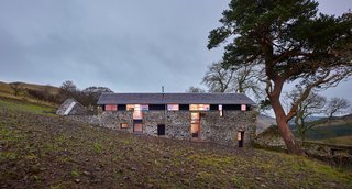 Another home by WT Architecture, The Mill is a former threshing mill that was transformed into a modern vacation home. Abandoned for 70 years prior to its renovation, the structure required significant work. The majority of the interior spaces are open-concept and lined with plywood and pine planks, and additional windows allow for views to the valley. 