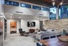 Modern home with Living Room, Bookcase, Console Tables, Chair, Shelves, End Tables, Coffee Tables, Concrete Floor, Lamps, Bench, Table Lighting, Storage, Recessed Lighting, Pendant Lighting, Sectional, Floor Lighting, and Rug Floor. The view from the kitchen. Photo 7 of Re-Open House