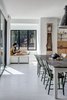 Modern home with Dining Room, Light Hardwood Floor, Chair, Storage, Table, Pendant Lighting, Shelves, and Bench. A reading nook fits perfectly into one of the cantilevered boxes. Photo 10 of Mullet House