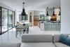 Modern home with Living Room, Pendant Lighting, Storage, Light Hardwood Floor, Chair, Table, and Stools. Mullet House by Matt Fajkus Architecture | Photo by Charles Davis Smith Photo 13 of Mullet House