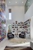 Modern home with Living Room, Shelves, Recessed Lighting, Light Hardwood Floor, Rug Floor, and End Tables. A double-height graffiti wall is bathed in natural light. Photo 14 of Mullet House