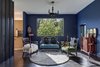 Modern home with Living Room, Rug Floor, Storage, End Tables, Pendant Lighting, Chair, Bench, and Dark Hardwood Floor. The sitting area is finished with dark surfaces and heavy, antique furnishings. Photo 7 of Mullet House