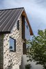 Modern home with Exterior, House Building Type, Wood Siding Material, Metal Siding Material, Metal Roof Material, Brick Siding Material, and Saltbox RoofLine. A close-up of the brickwork which is broken up by the unique, randomized brick coursing to help blend old and new bricks. Photo 17 of Mullet House